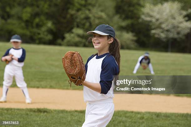 girl pitching in little league softball game - young baseball pitcher stock pictures, royalty-free photos & images