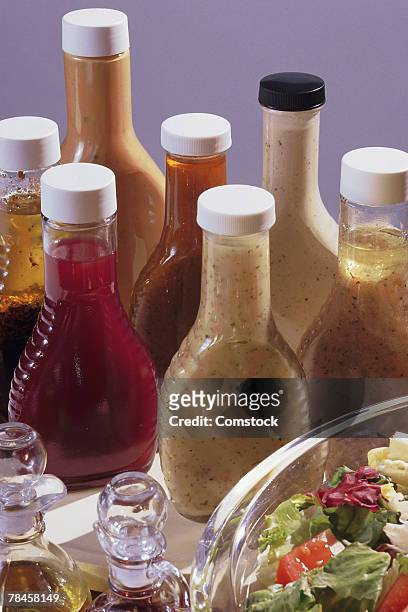 salad with assorted bottles of dressing - vinaigrette dressing ストックフォトと画像