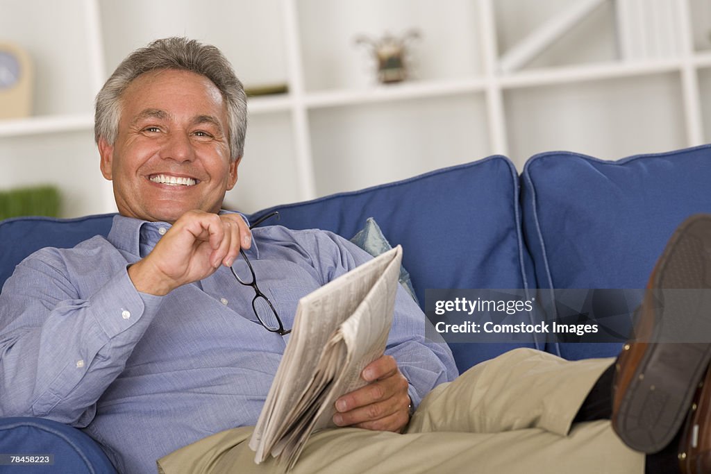 Man reclining with newspaper