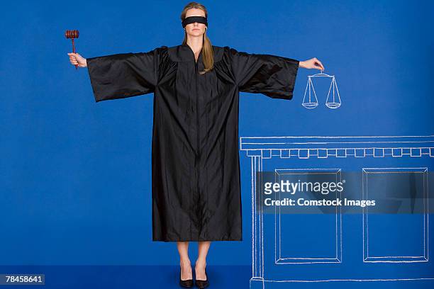 blindfolded judge holding gavel and scales - funcionário público imagens e fotografias de stock