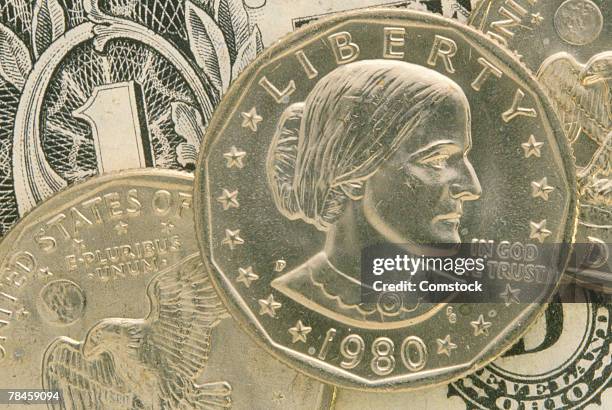 susan b anthony coin and a dollar bill - susan b anthony stock pictures, royalty-free photos & images