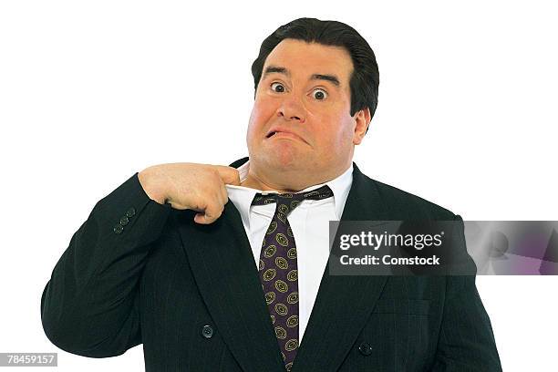 worried businessman loosening his collar - unhappy salesman stock pictures, royalty-free photos & images