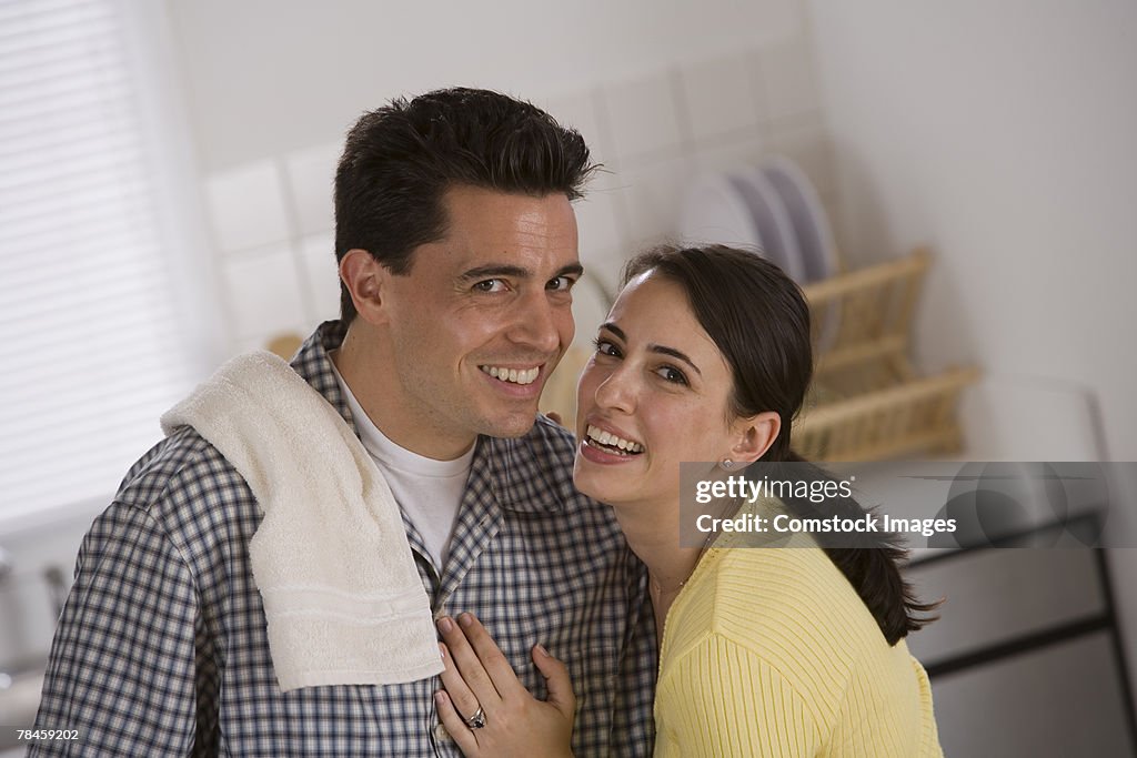 Woman hugging man in kitchen