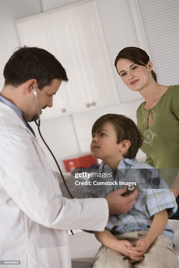 Mother watching son during doctor's examination