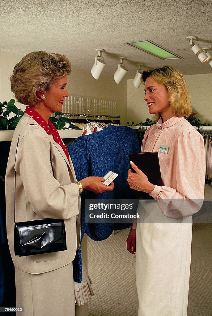 Women in retail clothing store with saleswoman