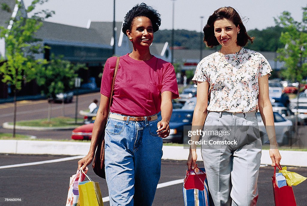 Women walking through parking lot with shopping bags