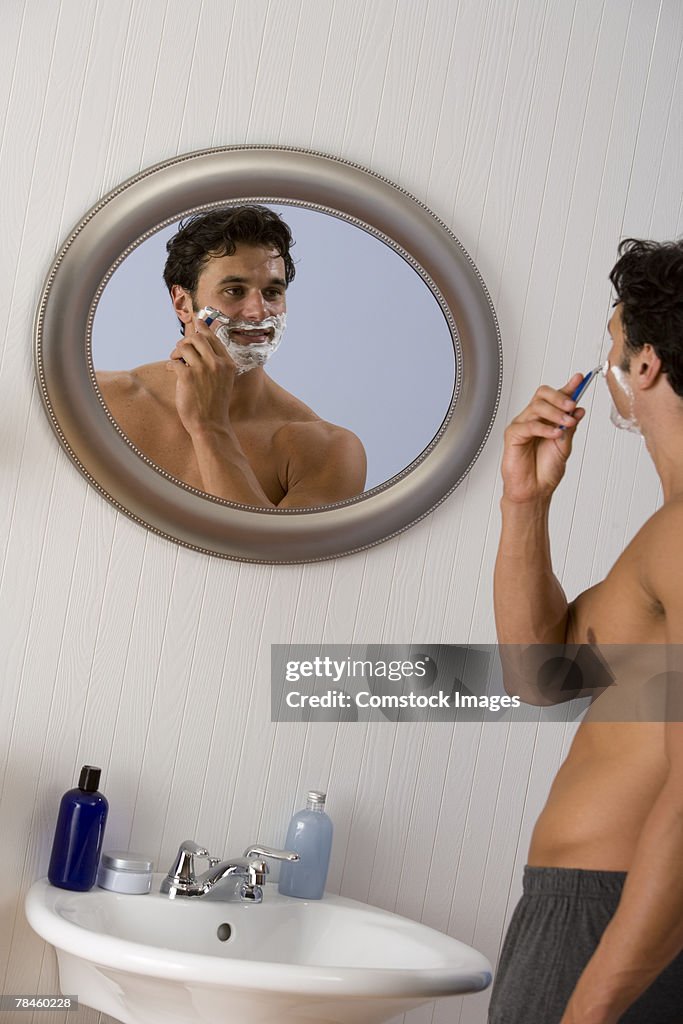 Man shaving face with razor