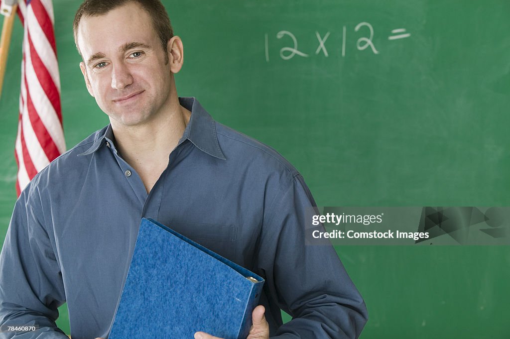 Teacher standing near chalkboard