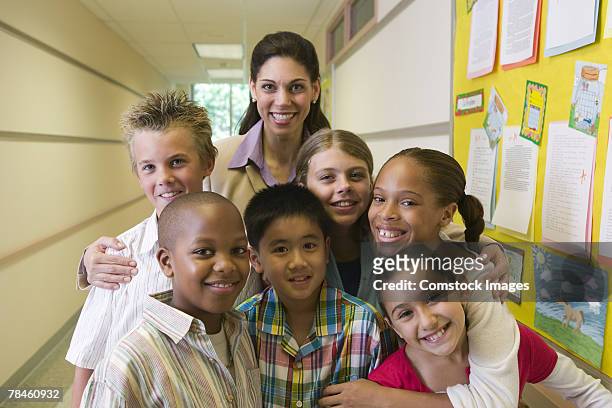 teacher and students posing in hallway - school principal stock pictures, royalty-free photos & images