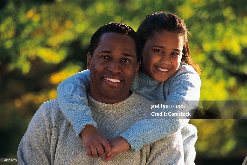 Father and daughter posing outdoors