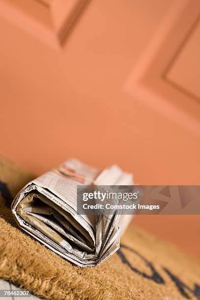 newspaper on porch - doormat stock pictures, royalty-free photos & images