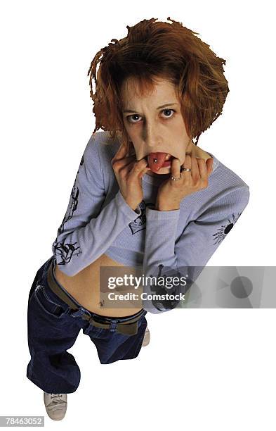 woman sticking out tongue - tongue stud stock pictures, royalty-free photos & images