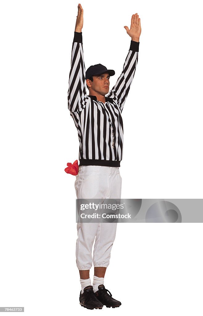 Football referee signaling touchdown