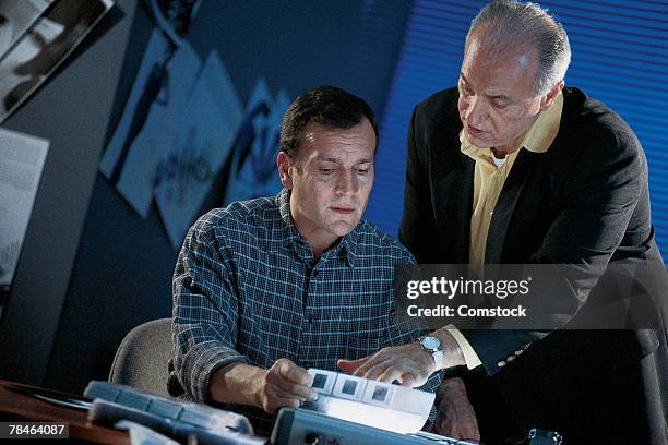 men looking at light box - 45 2001 stock pictures, royalty-free photos & images
