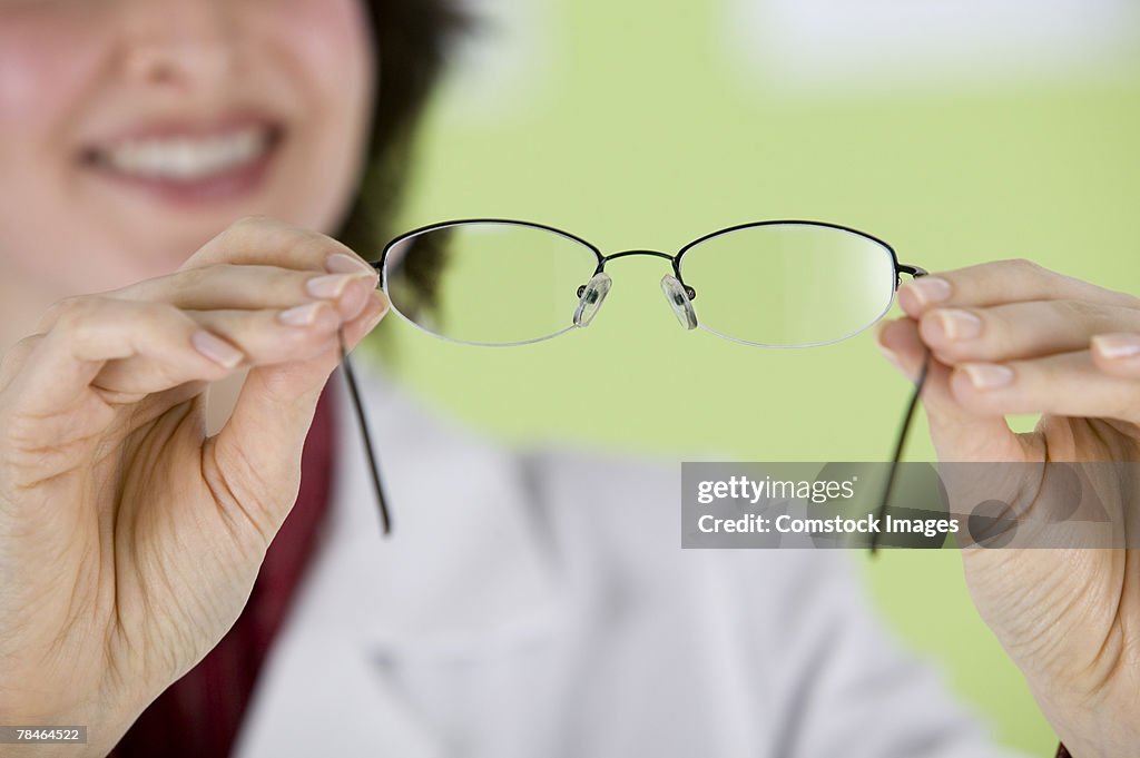Eye doctor holding up eyeglasses