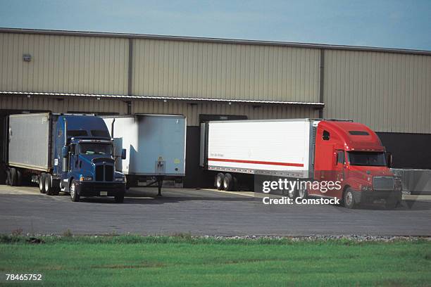 tractor trailers backed into loading dock - loading docks stock pictures, royalty-free photos & images
