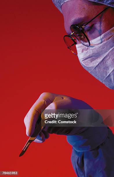 profile of doctor with scalpel - surgical mask profile stock pictures, royalty-free photos & images