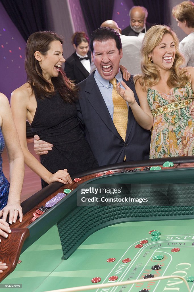 Excited people playing casino game