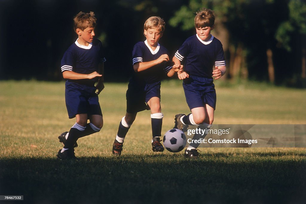 Boys kicking a soccer ball