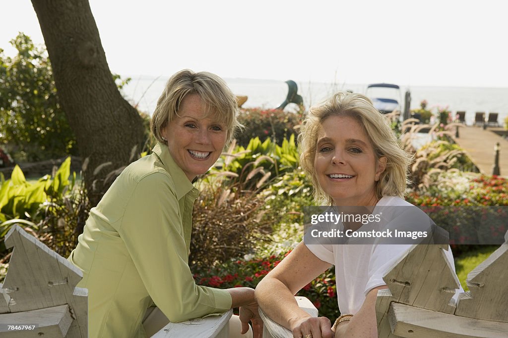 Women sitting in garden by ocean