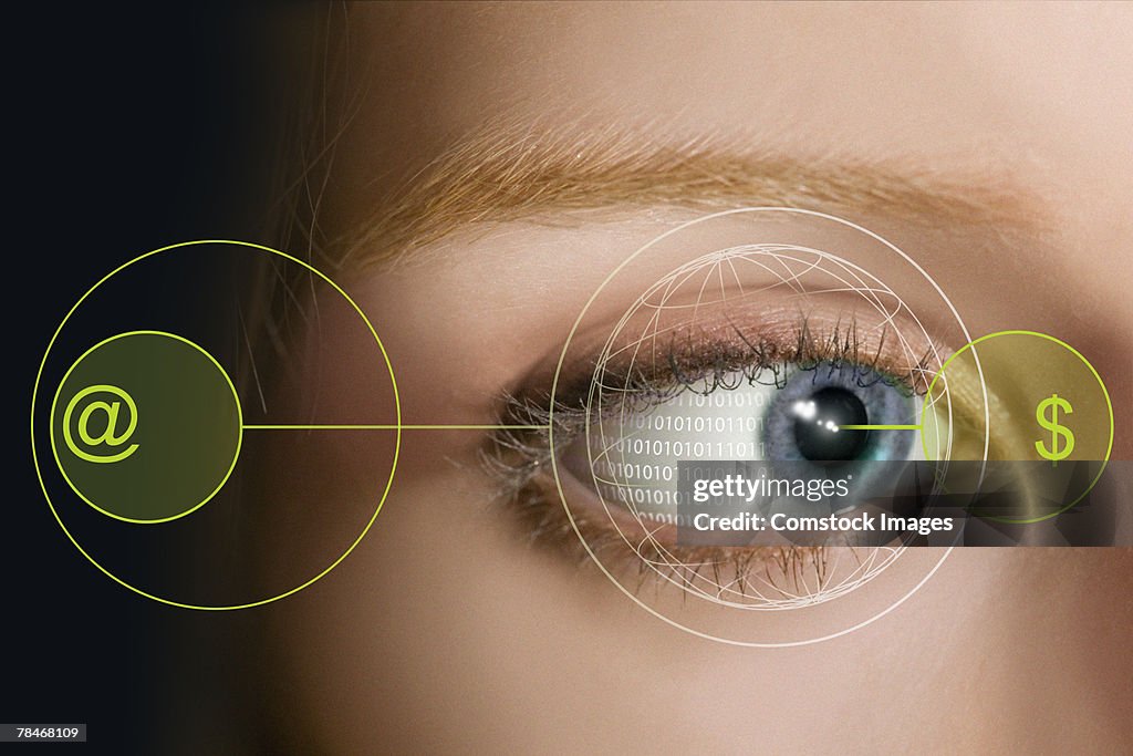 Closeup of a woman's eye with symbols and binary code