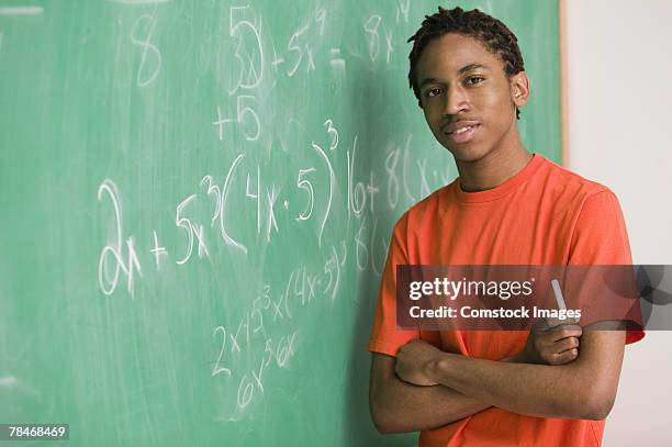 teenage boy with chalk by chalk board - high school maths stock pictures, royalty-free photos & images