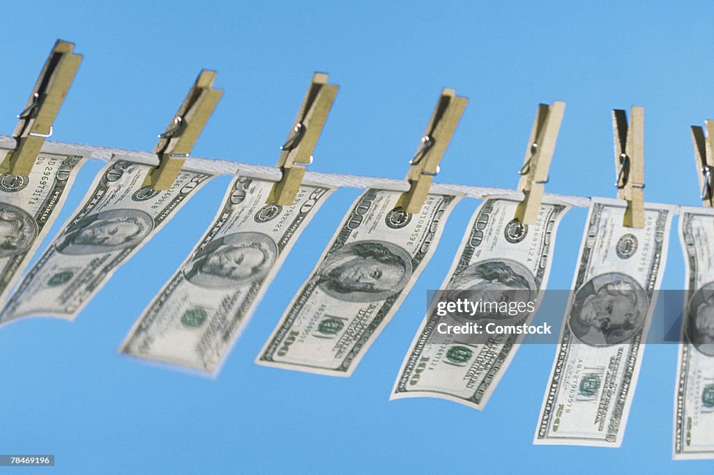 American bills hanging on clothesline