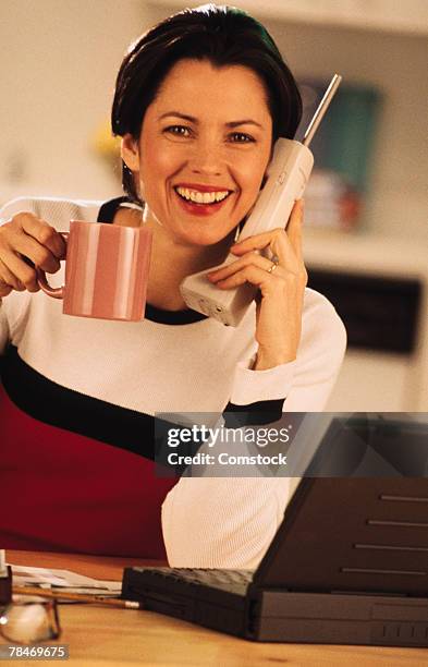 woman with coffee mug talking on telephone - 1998-25-29 stock pictures, royalty-free photos & images