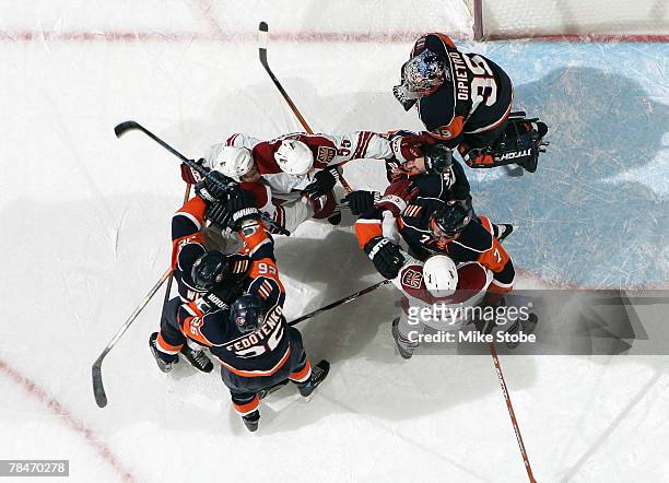 Goaltender Rick DiPietro, Brendan Witt, Ruslan Fedotenko, Trent Hunter and Radek Martinek of the New York Islanders get into a pushing match with...