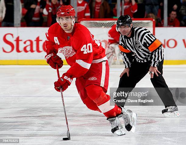 Henrik Zetterberg of the Detroit Red Wings begins his shootout attempt on Dwayne Roloson of the Edmonton Oilers during an NHL game on December13,...
