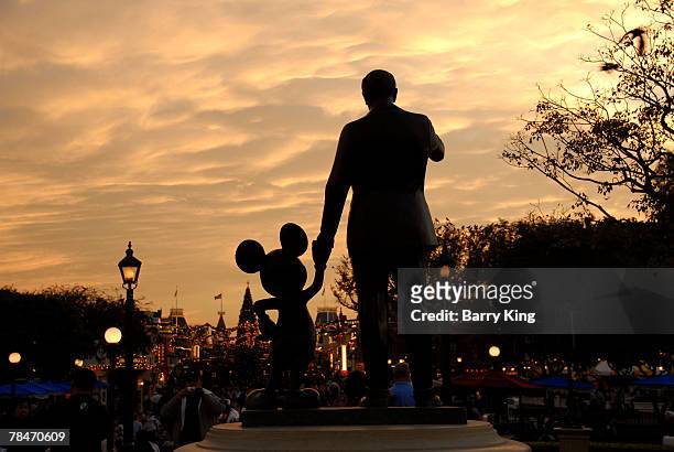 Statue of Mickey Mouse and Walt Disney at Disneyland's Sleeping Beauty's Holiday Castle and "Believe In Holiday Magic" Fireworks spectacular held at...