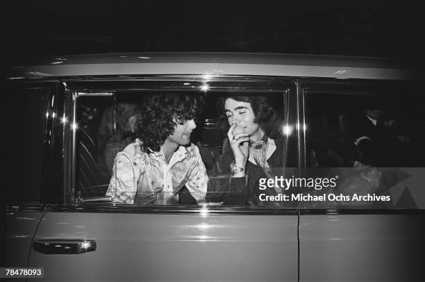 Rock band 'Led Zeppelin' ride in a white limousine adorned with various groupies outside of Rodney Bingenheimer's English Disco in June 1972 in Los...