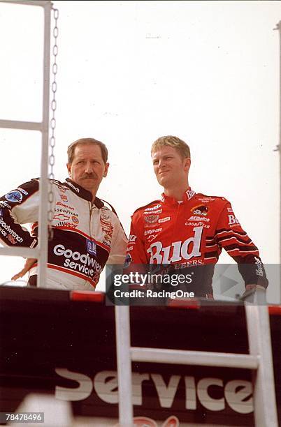 Dale Earnhardt, Sr. And Dale, Jr. Share a quiet moment while watching other cars practice at the track inTalladega, Alabama on October 15, 2000....