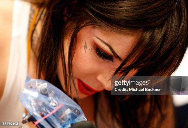 Tattoo artist Kat Von D inks a tattoo on someone in an attempt to break the 24-hour Guinness World Tattoo Record at LA Ink December 14, 2007 in West...
