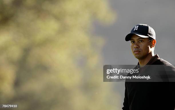 Tiger Woods stands on the 18th fairway on his way to ending the day with a course record 10 under par during the second round of the Target World...