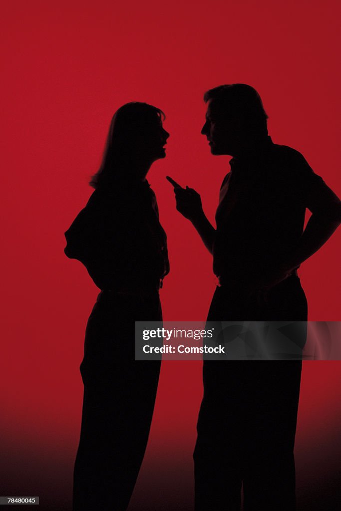 Silhouettes of people arguing