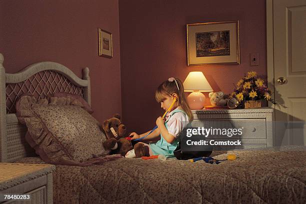 young girl playing doctor - vestita da dottoressa foto e immagini stock