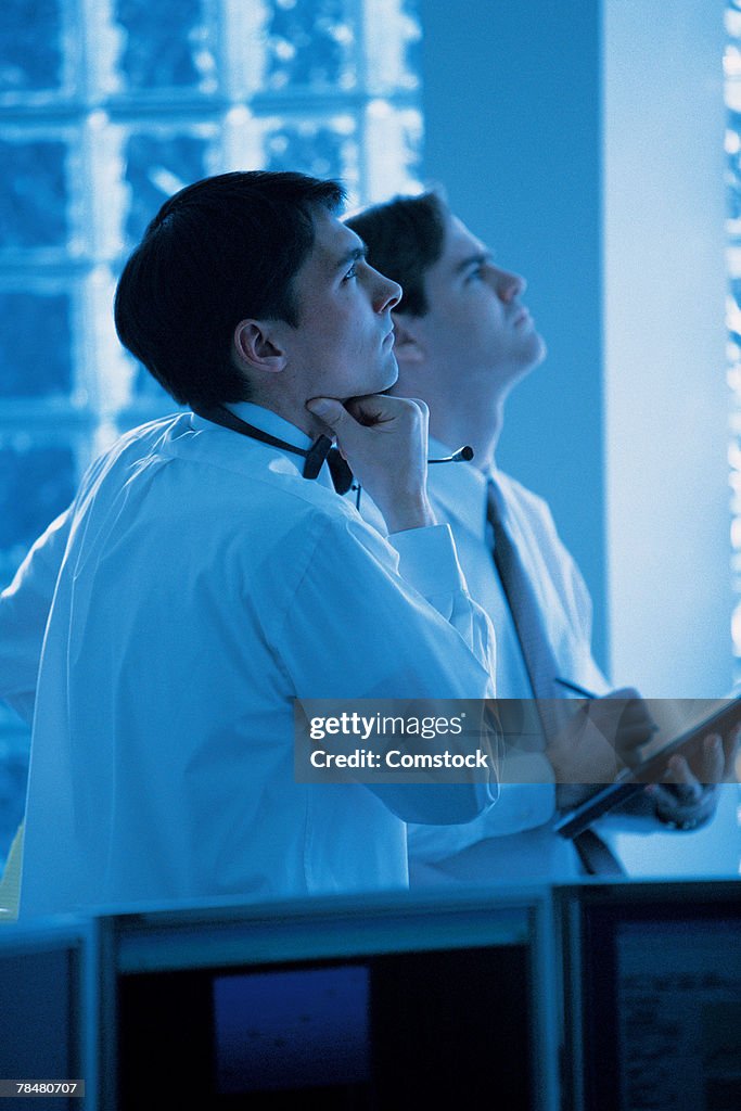 Businessmen in office looking up