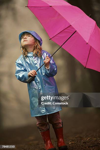 girl with umbrella - rain hat stock pictures, royalty-free photos & images