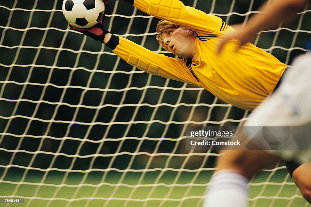 Soccer goalie blocking ball