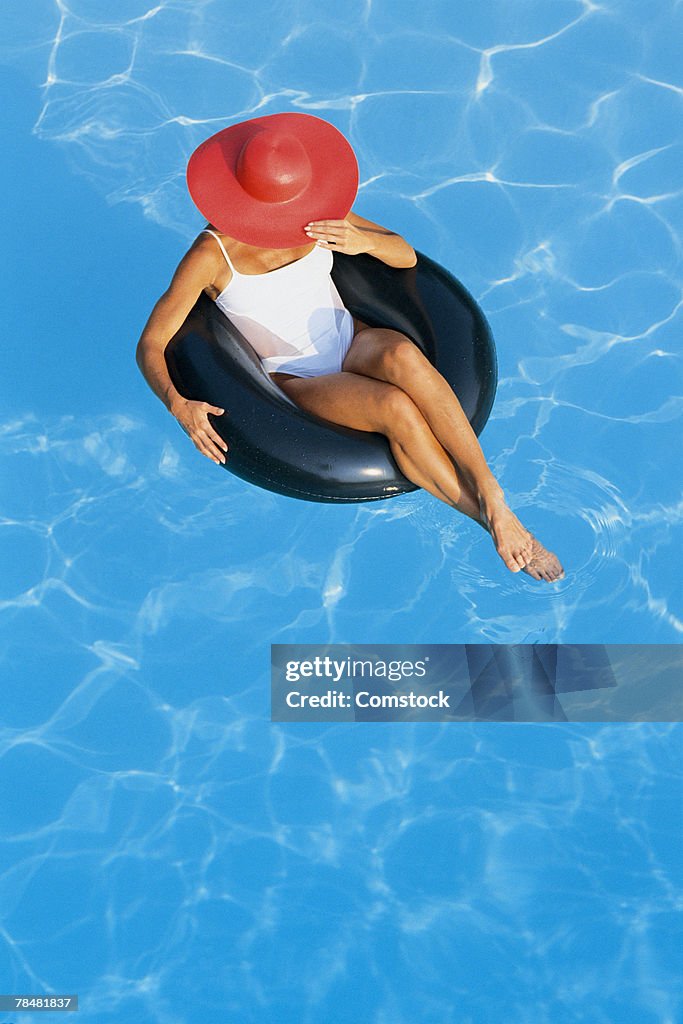 Woman in inner tube in pool