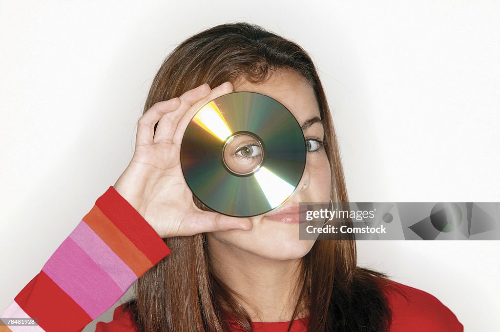 Teenager looking through CD
