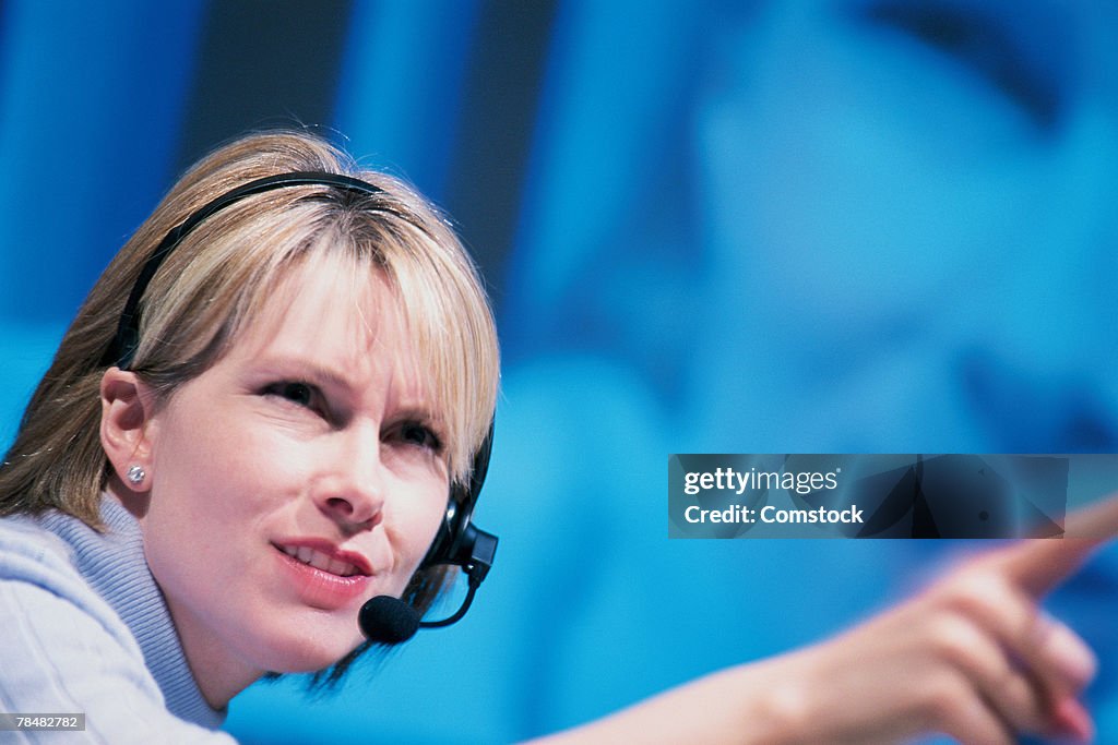 Woman with microphone pointing