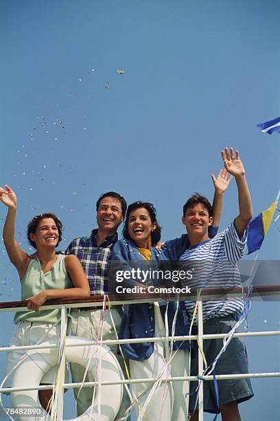 couples waving bon voyage on cruise ship - bon voyage stock pictures, royalty-free photos & images