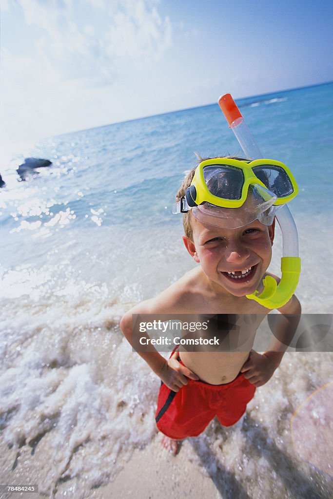Boy on beach with snorkel