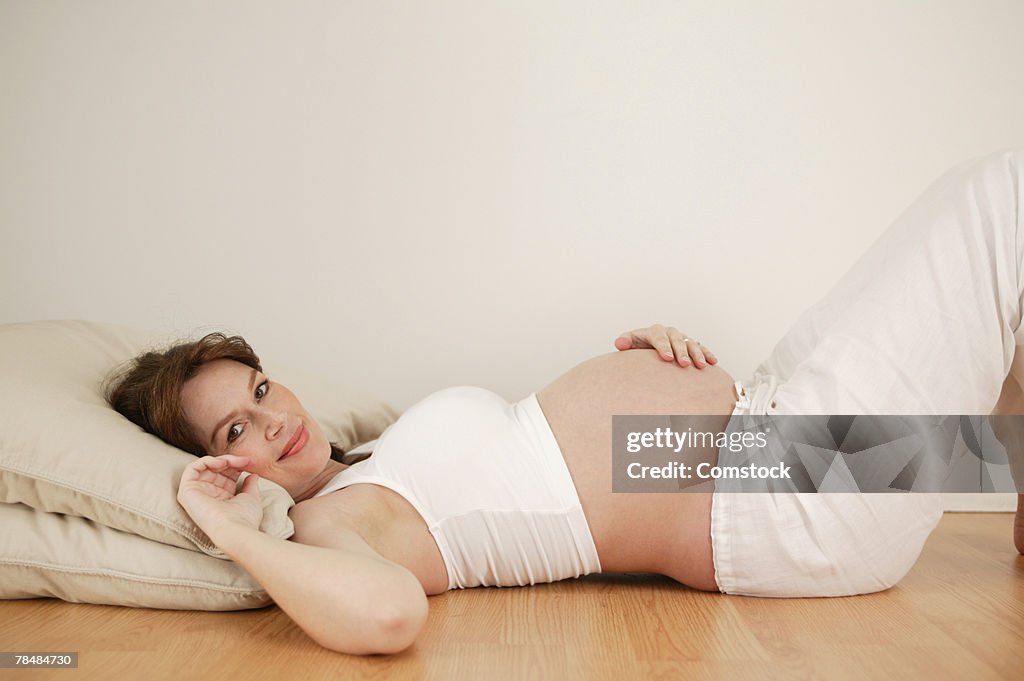 Pregnant woman lying on floor