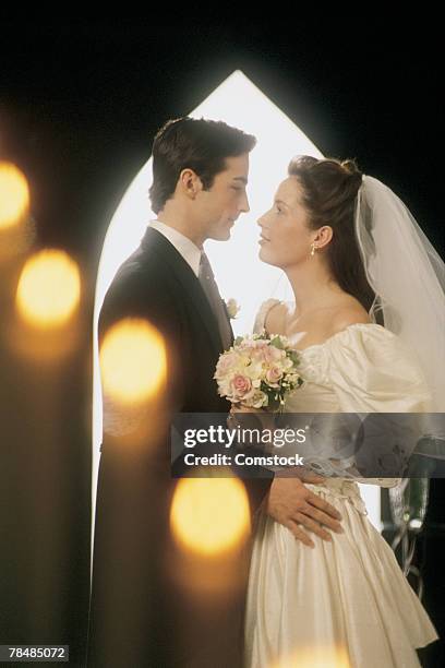 bride and groom at altar in church - man tuxedo profile stock pictures, royalty-free photos & images