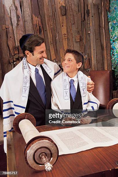 father with son in temple during bar mitzvah ceremony - bar mitzvah stock pictures, royalty-free photos & images