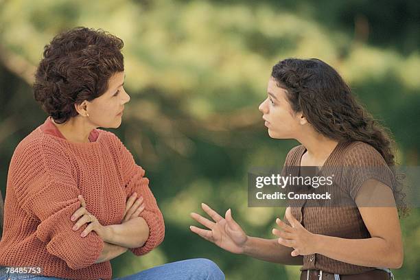 mother and daughter arguing outdoors - mom arms crossed stock pictures, royalty-free photos & images