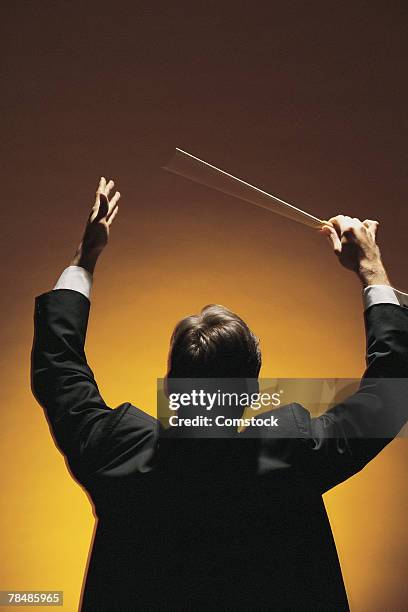 symphony conductor conducting - conductor leading orchestra stock-fotos und bilder